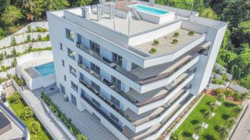 Apartments in a new building with a sea view, shared pool, garage in Opatija 