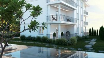 A large apartment with a terrace in a new building of authentic architecture with a swimming pool near the sea and Opatija in Icici 