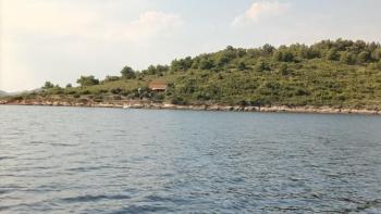 Larger part of a green island within beautiful Kornati archipelago 